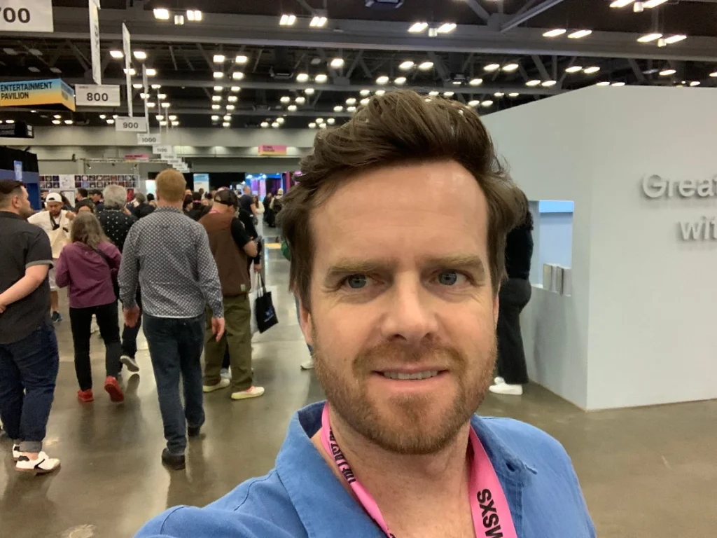Selfie of smiling Rhys in the festival hall of SXSW. 